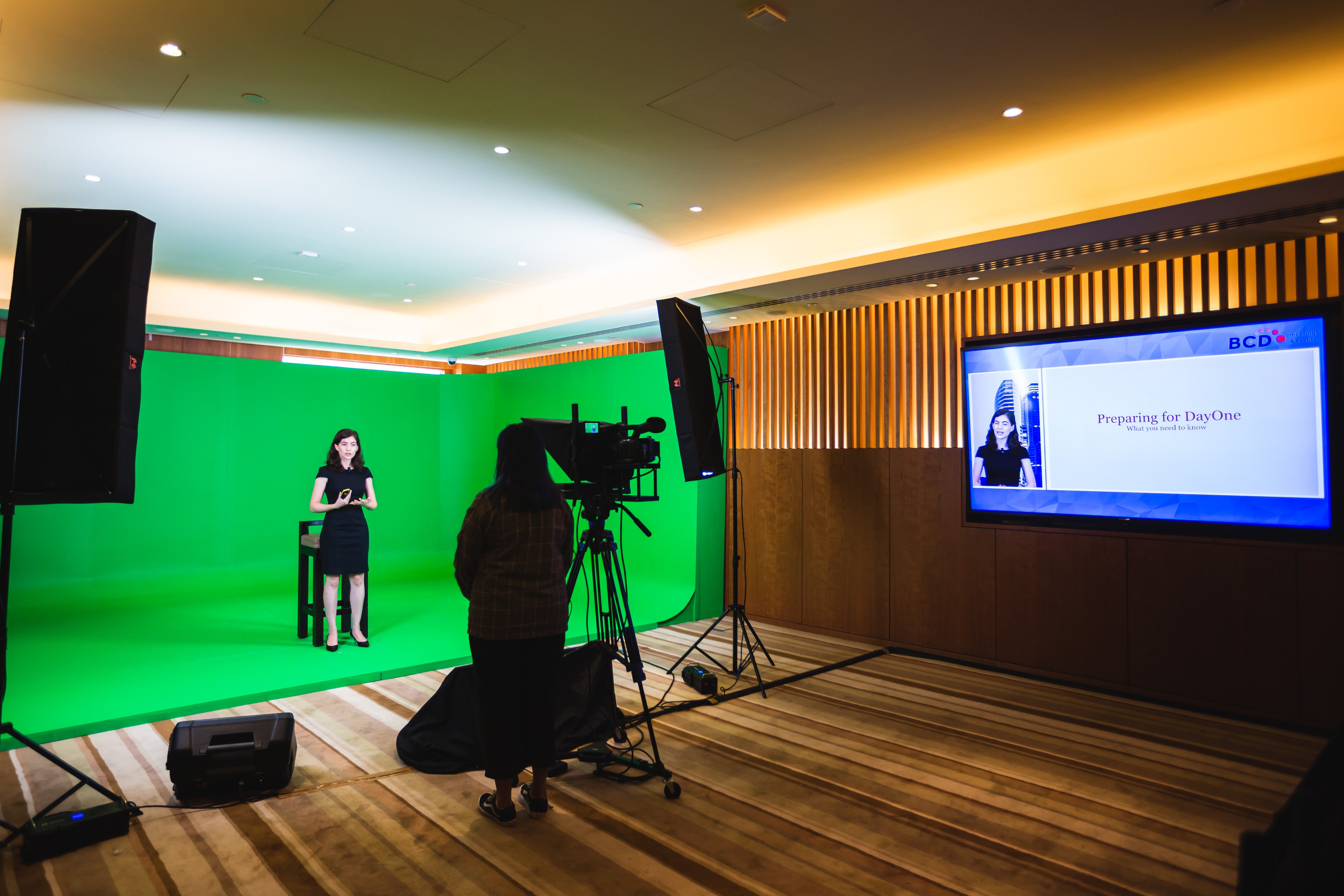 Virtual speaker standing in front of green screen and camera for Hybrid Event Showcase | Global agency, BCD Meetings & Events