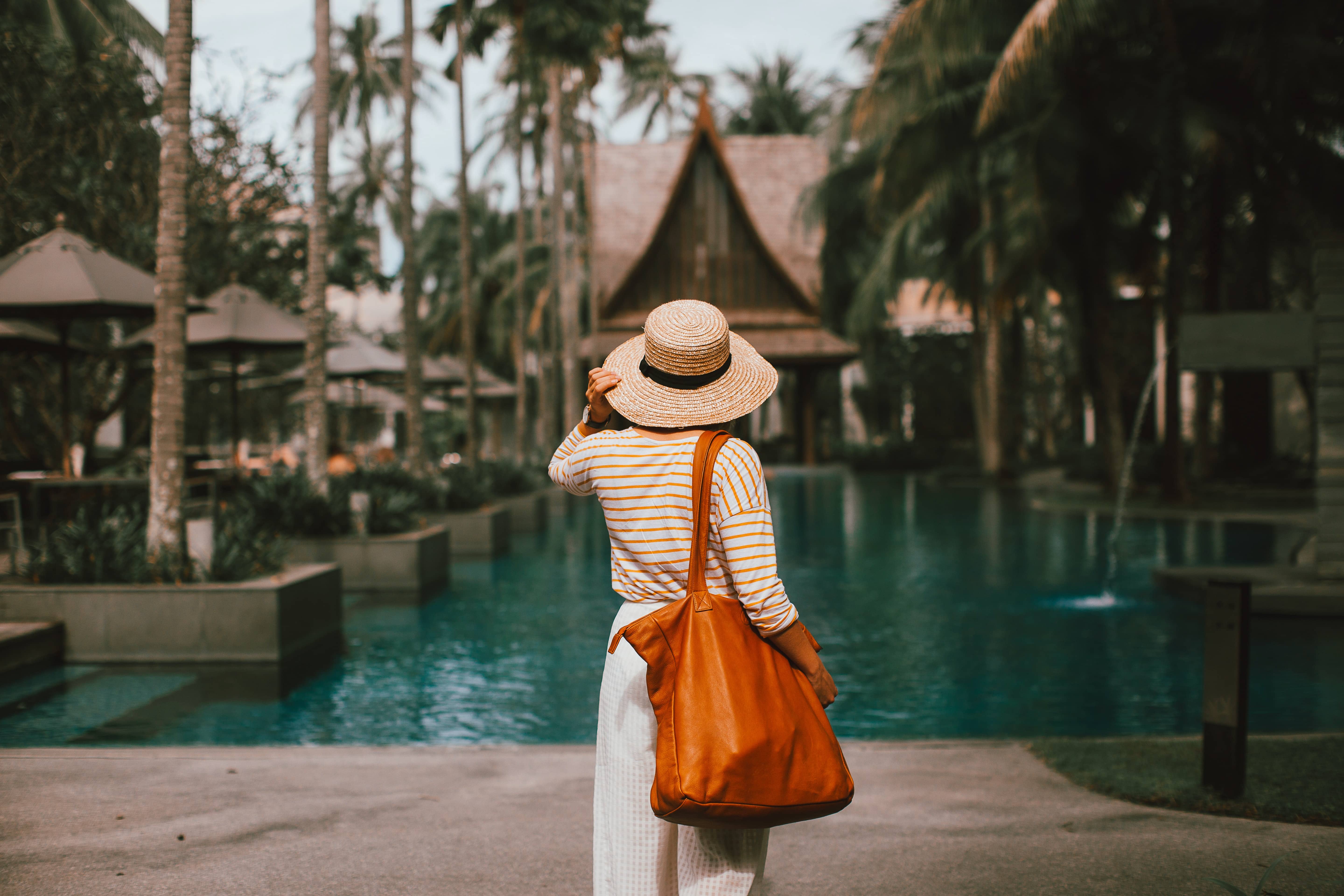 Female corporate bleisure traveller standing outside of her hotel and accommodations | Global Agency BCD Meetings & Events