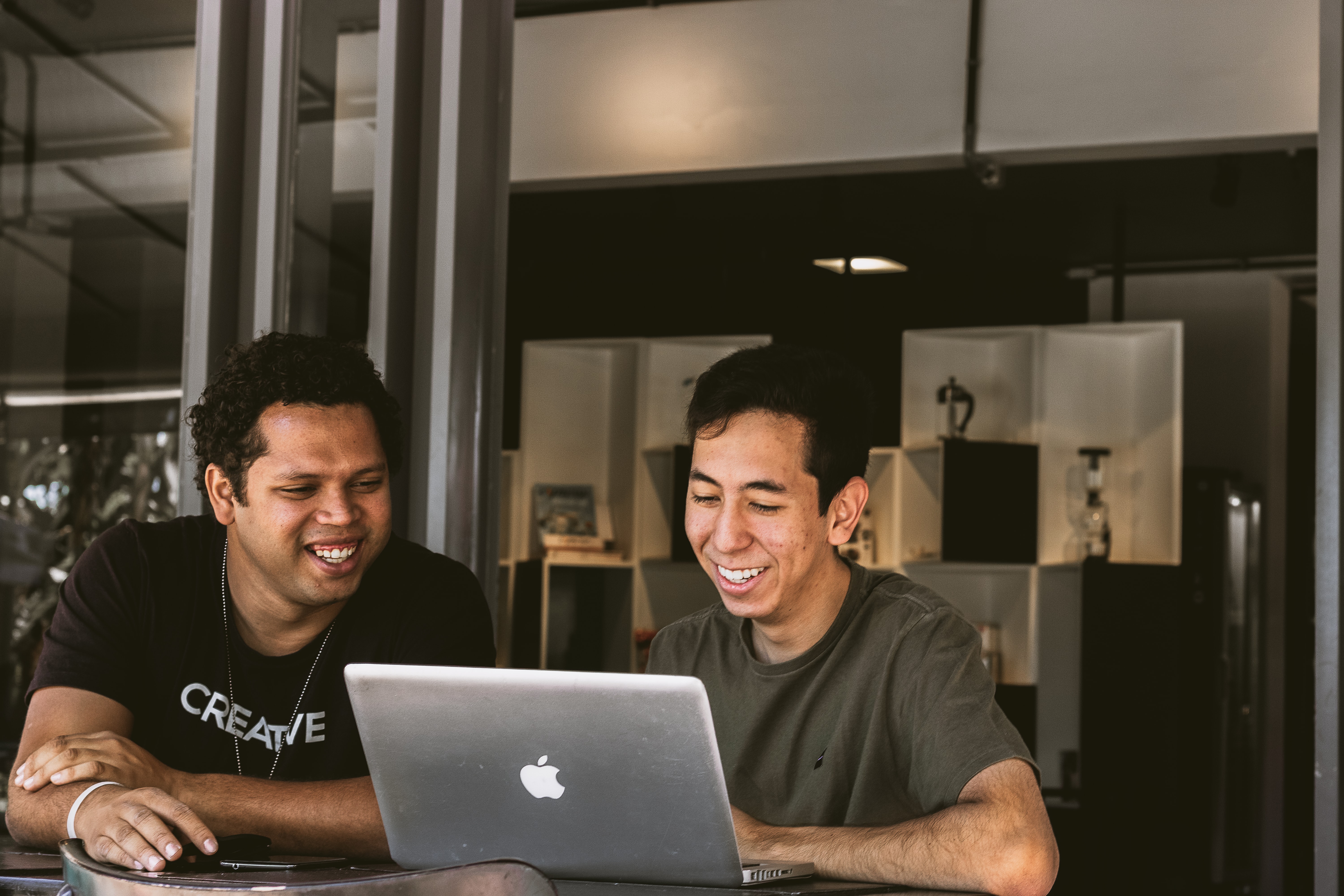 Two men using a laptop to perform venue search tasks for corporate meeting planning | Global agency, BCD Meetings & Events