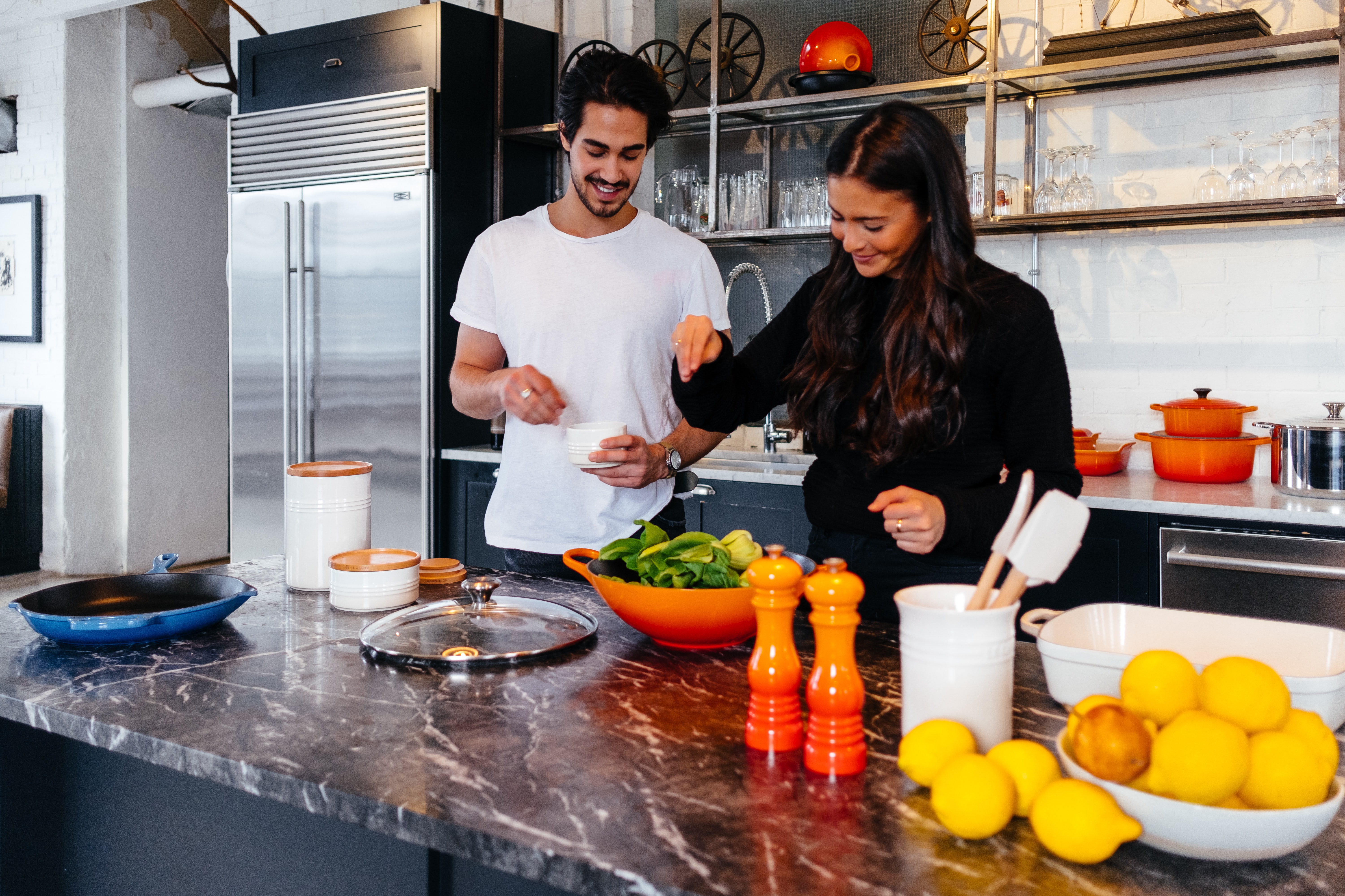 A man and woman cooking together in a kitchen as part of an Incentive Experience | BCD Meetings & Events