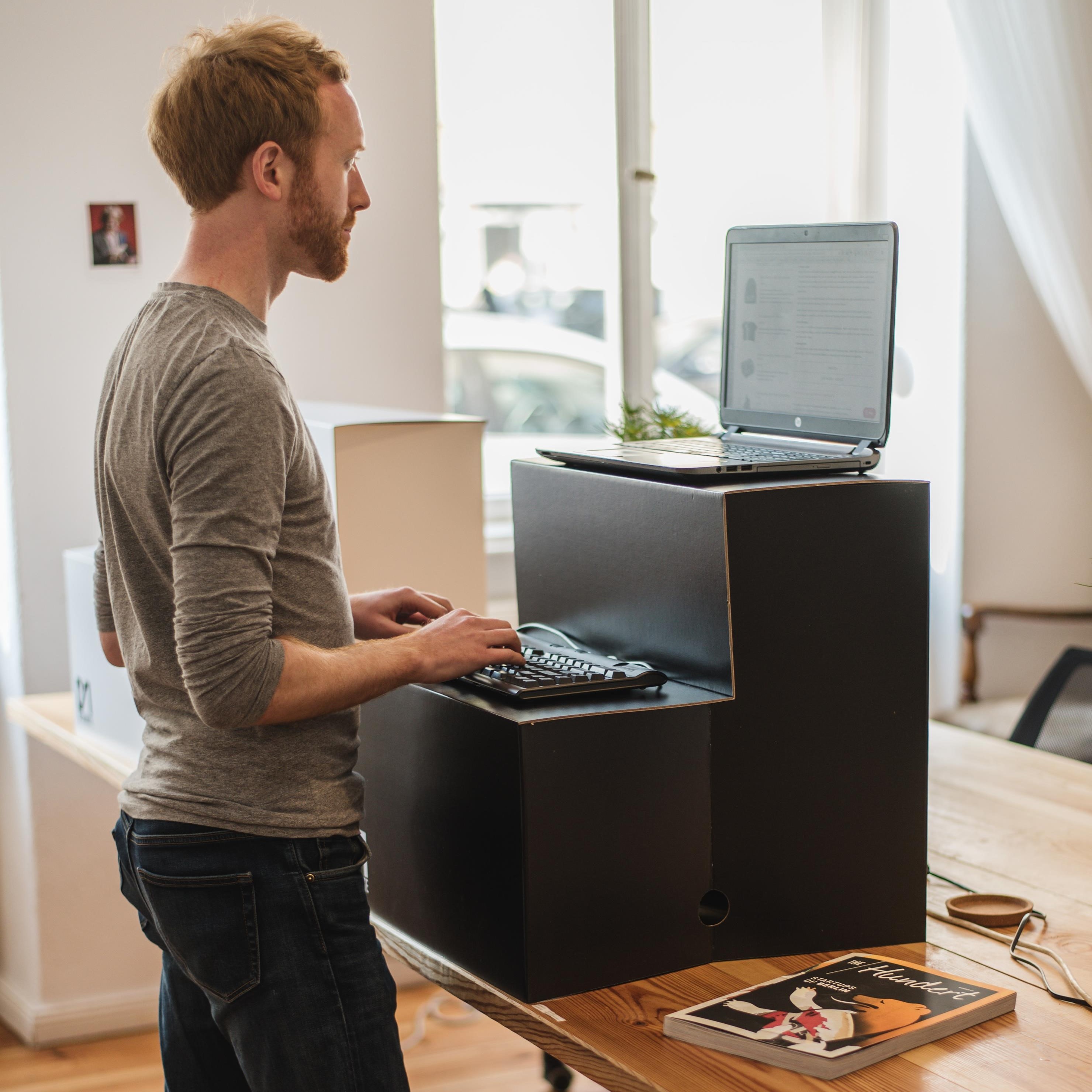 Man working on laptop at standing desk | Global agency, BCD Meetings & Events