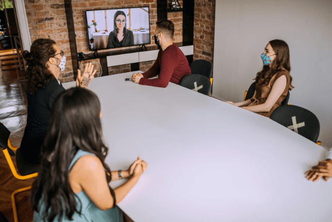 A group of event planners sat in a meeting room having a conversation | Global Agency. BCD Meetings & Events