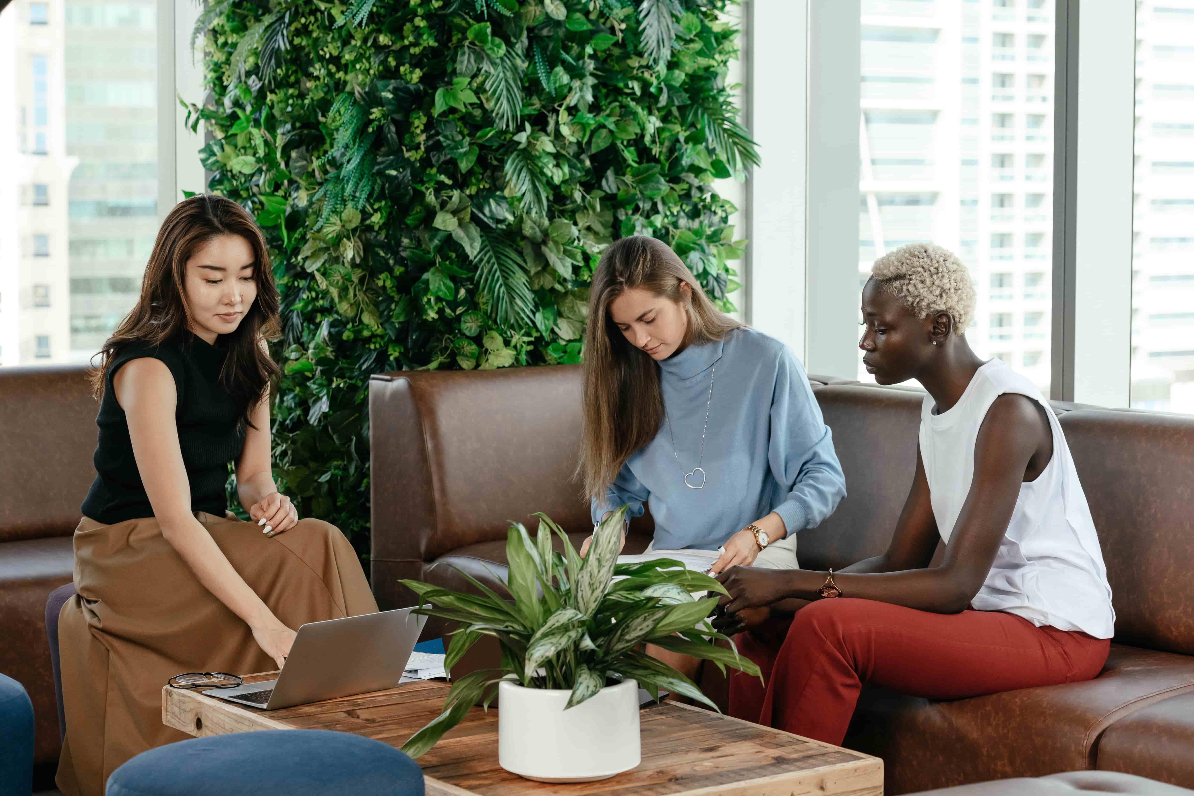 Three meeting planners sat in a office surrounded by plants | Global Agency. BCD Meetings & Events 