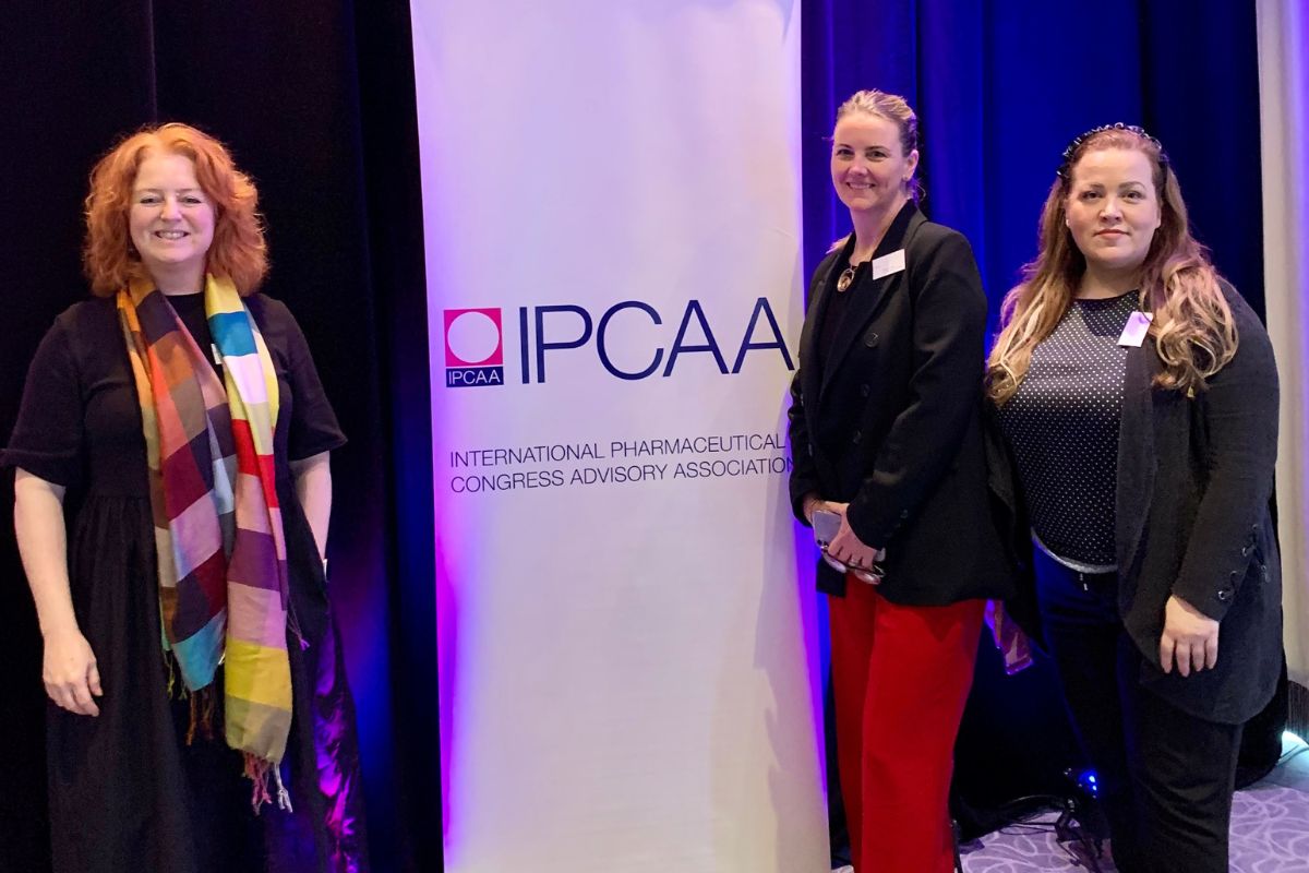 BCD Meetings & Events speakers standing in front of IPCAA signage