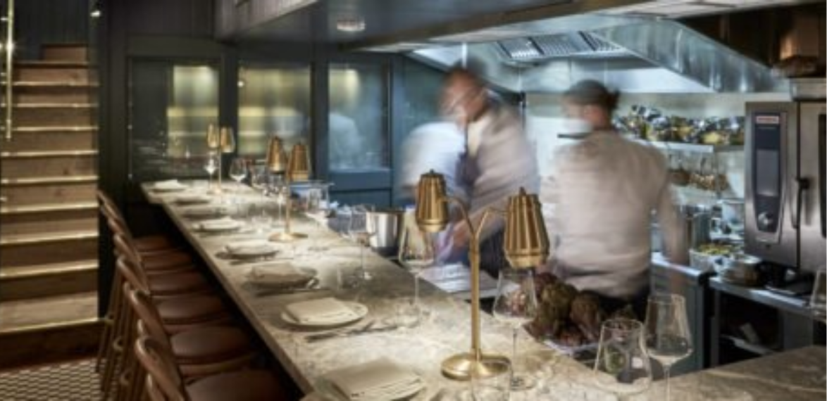 Chefs working at a counter with table lamps
