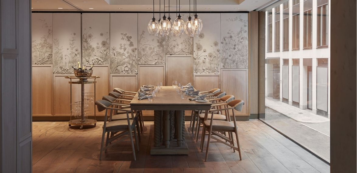 8 seater wooden table with hanging lights and wooden floors