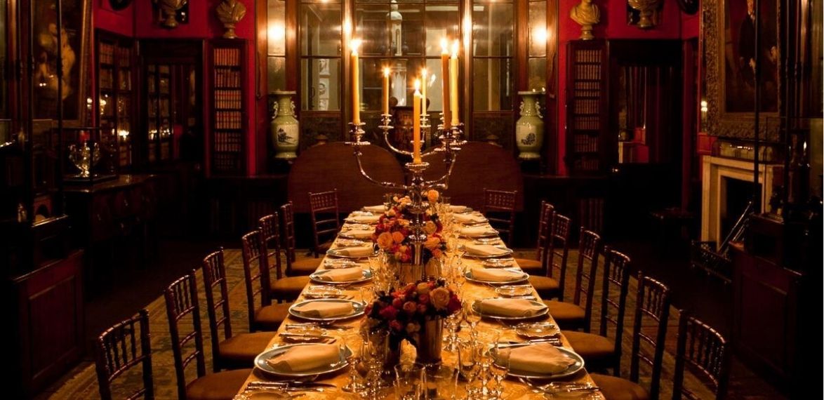 table with candles and flowers in a darkly lit room
