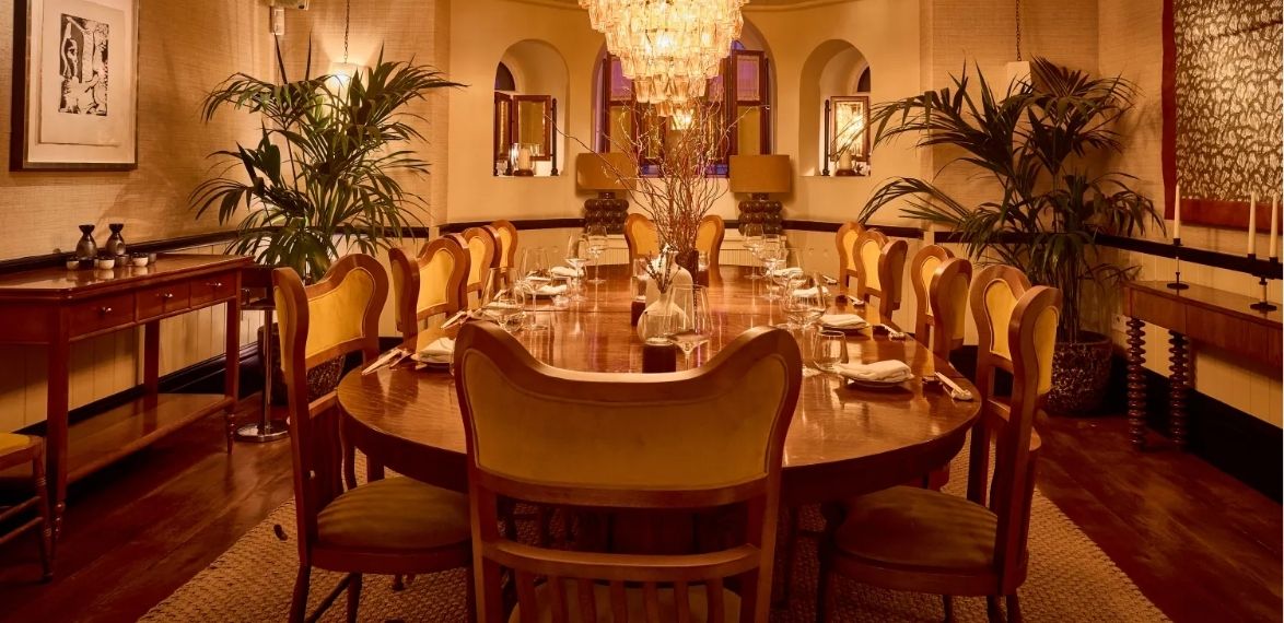 dining space with chandelier and chairs with plants