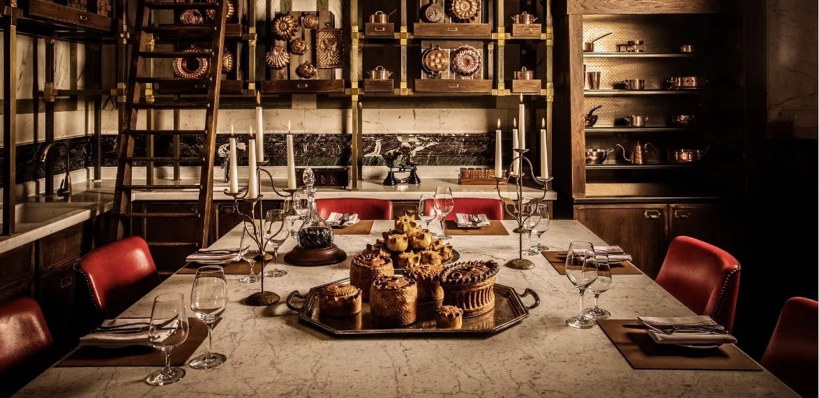 A pile of pies on a table with candles and vintage background
