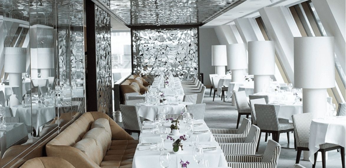 White clothed table with large windows