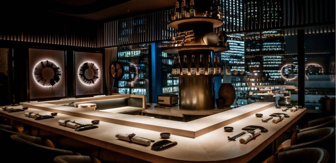 chefs table set up in the evening with buildings outside