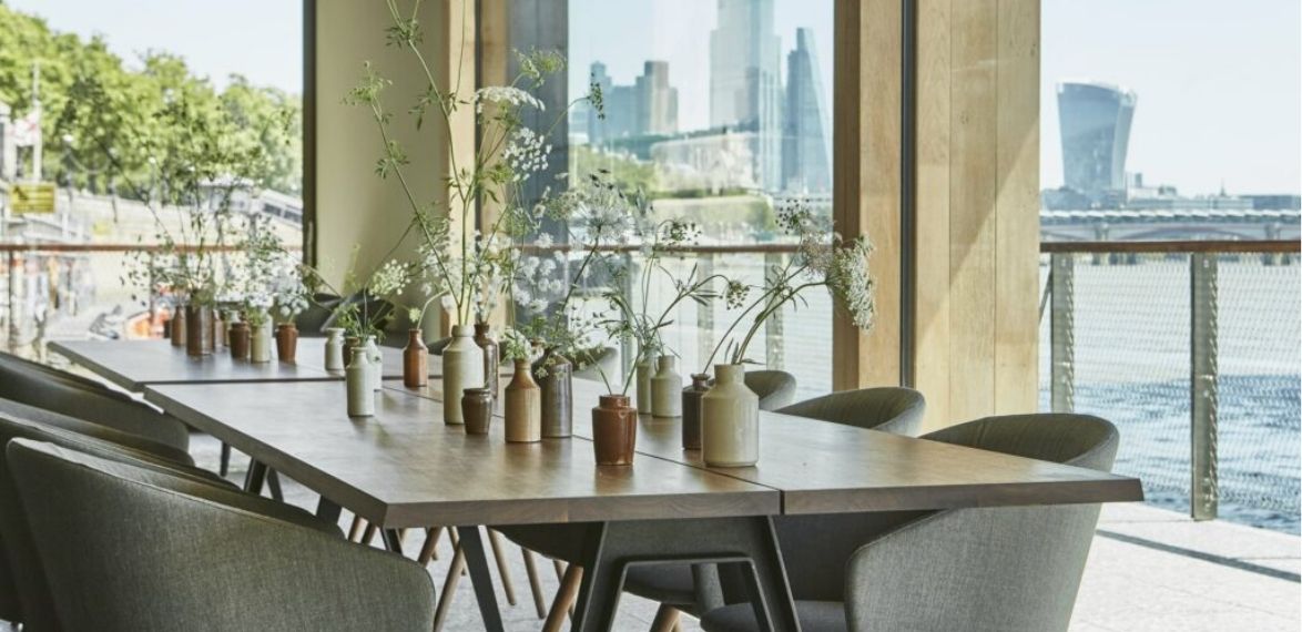 Flowers on a long wooden dining table